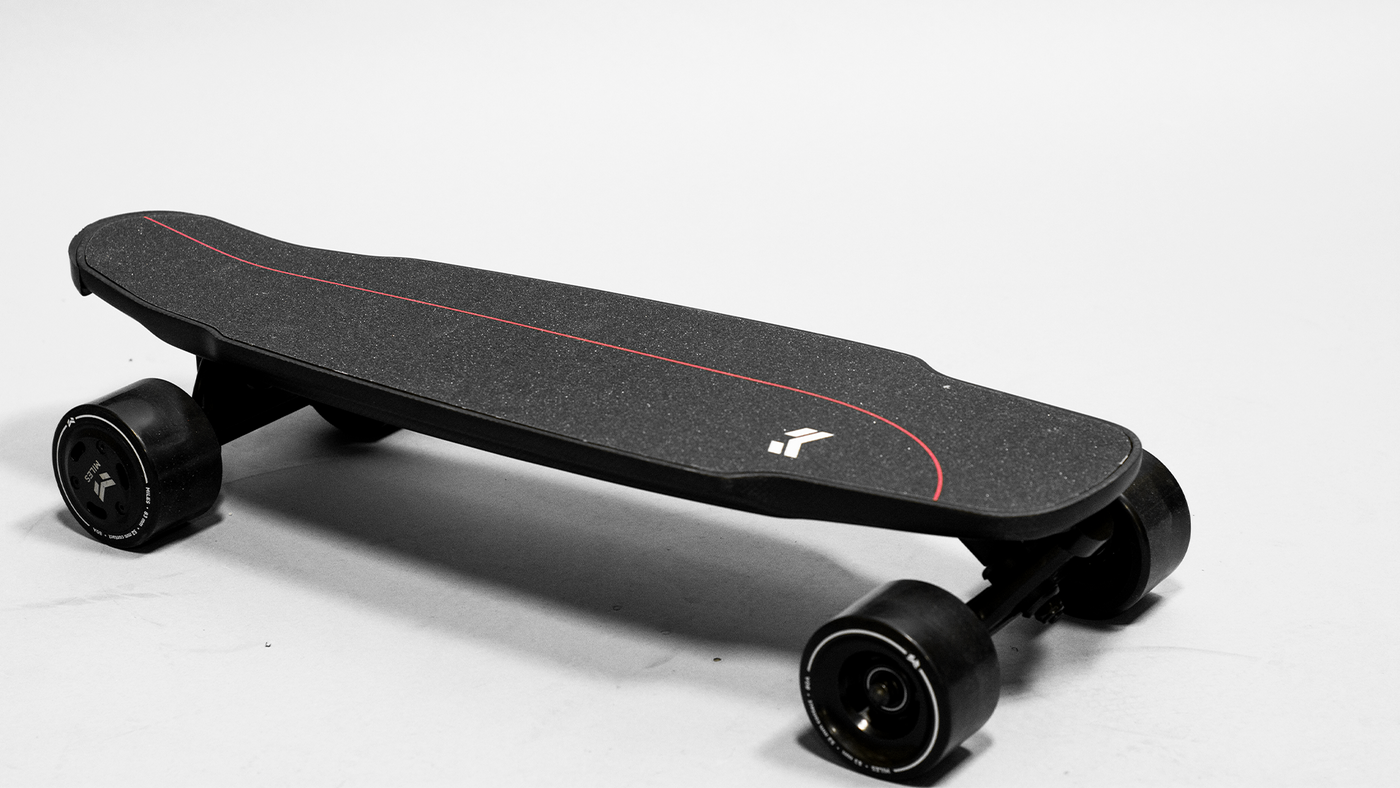 Dual electric shortboard with black wheels and miles logo